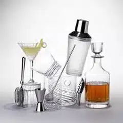 A cocktail shaker, jigger, strainer and decanter